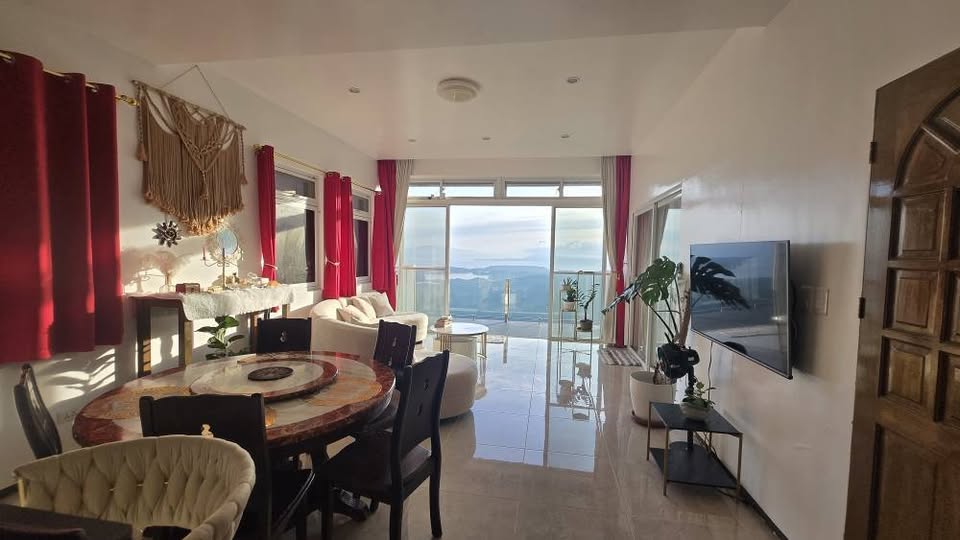 Living and dining room facing the panoramic balcony